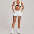 Women's white two-piece yoga set with black trim sports bra and high waist pocket shorts - S / White