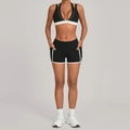 Two-piece black and white patchwork yoga set with halter sports bra and pocketed shorts - S / Black