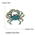 Goldene Krabbenbrosche mit hellblauen Kristallen und schwarzen Edelsteinaugen, 3,3 cm x 3,9 cm - Blau-4133