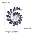 Broche de corona de olivo plateada con cristales azul marino y una perla central - Azul
