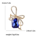 Elegant gold bow brooch with blue crystal gemstone and rhinestones, 4.2cm in size - Blue