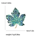 Elegante spilla a foglia d'acero con cristalli blu e verdi su base dorata - Blu