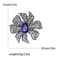 Detail showing rhinestone flower brooch dimensions 9.5cm by 8.5cm with blue pear-cut stone - Blue
