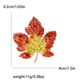 Elegant maple leaf brooch with red and orange crystals and golden alloy base - Red