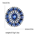 Lussuosa spilla a raggiera con grande cristallo blu ovale e base in metallo dorato - Blu