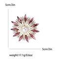 Elegant purple crystal sunburst brooch with white pearl in a 5cm golden finish - Purple
