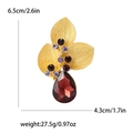 Retro matte gold triple leaf brooch with red rhinestone measuring 6.5cm by 4.3cm - Gold