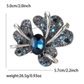 Elegant silver iris brooch with blue oval gemstone and gradient crystal pavé rhinestones - Blue