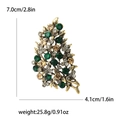Spilla a foglia oro vintage con strass verde smeraldo e color champagne decorati - Verde