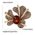 Vintage gold iris brooch with champagne rhinestones and a large amber gemstone - Light Coffee