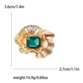Detaillierte Größentabelle für goldene Blumenbrosche mit grünem Stein und Abmessungen - Grün