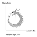 Silver-tone circular dragon brooch with sparkling rhinestones and black gem eye - Silver