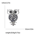 Vintage hollow owl brooch with blue rhinestones and silver metal finish, size 6.9cm by 5.0cm - Blue