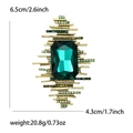Detail shot of vintage style brooch with emerald green crystal and golden metallic frame - Rectangular 3D Brooch (MM-BR-4387) / Antique Gold-Dark Green