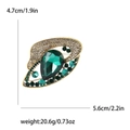 Vintage gold brooch with a pear-cut green crystal and rhinestone accents, 5.6cm wide - Green