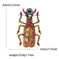 Detailed view of rhinestone beetle brooch with dimensions 6.8cm height and 4.4cm width - Brown