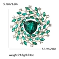 Golden alloy floral brooch featuring a large emerald-cut green crystal and white rhinestones - Green (4443-GN)
