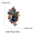 Vintage Blumenbrosche aus Goldlegierung mit bunten Strasssteinen und blauem Edelstein - Mehrfarbig