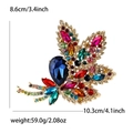 Elegant gold maple leaf brooch with multicolored rhinestones and deep blue gem - Multicolor (MM-BR-4440)