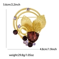 Elegante spilla a corona di foglie dorate con strass viola e gemme rosse da donna - Oro