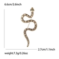 Spilla serpente vintage dorata con occhi di strass verdi e strisce nere su sfondo bianco - Oro