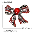 Vintage gold hollow bow brooch with sparkling red rhinestones and a large teardrop gem - Red