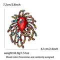 Detailed close-up of a colorful crystal fireworks brooch with red pear-shaped center stone - Colorful