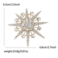 Détail d'une broche étoile en strass montrant les dimensions 6,3 cm sur 6,8 cm et un poids 24,8 g - Doré