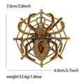 Overdreven spinnenweb broche met oranje steentjes en een bruin diamanten kristal - Bruin