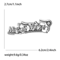 Detailed close-up of alloy barber brooch with scissors and Miracle Worker text - Silver