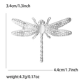 Dragonfly brooch with hollow enamel wings and white cat eye stone in silver finish - Silver