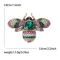 Colorful alloy bee brooch with emerald-cut green crystal and rhinestone wings on white background - Emerald Green Style