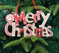 Red and white glitter Merry Christmas sign ornament hanging on a green Xmas tree - Gold Red