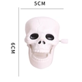 Halloween clockwork skull toy in white plastic with 5cm width and 6cm height dimensions - Skull Style