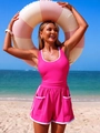Detail of pink two-piece sporty swimsuit with white trim and shorts on beach setting - S / Rose Red + White