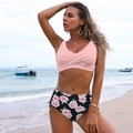 Detail of pink crossover bikini top and high-waisted floral bottoms on beach - S / Top And Bottom / Pink Black Flower