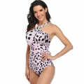 Pink one-piece swimsuit with black cow print, halter neck cross design and cutout detail - M / Pink Leopard