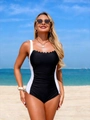 Close-up of black and white one-piece swimsuit with scalloped neckline and ruched waist - S / Black + White
