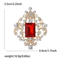 Detail view showing dimensions 5.5x4.4cm of a vintage gold brooch with red gemstone - Red