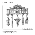 Detailed view of silver medical brooch with hanging nurse hat and stethoscope charms - Hospital Medical Pendant (5188-SL) / Antique Silver
