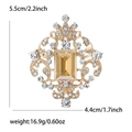 Vintage baroque brooch with amber crystal center, golden finish and clear rhinestones - Champagne