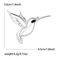 Silver hummingbird brooch with black gem eye and hollow wing detail in flying pose - Silver