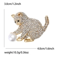 Detail view of cat brooch with rhinestones and pearl, measuring 3.0cm by 4.0cm - Gold