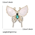 Elegant butterfly brooch with shell wings, green gems and crystals on a white background - Hollow Butterfly Style / Gold