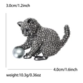Elegant cat brooch with grey rhinestones playing with a large pearl bead accessory - Black