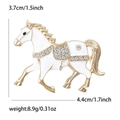 Macro shot showing horse brooch dimensions 4.4x3.7cm and detailed white enamel inlay - Gold-White