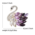 Elegant gold-tone swan brooch featuring colorful marquise crystals and pavé rhinestones - Purple