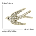 Golden alloy swallow brooch with white imitation pearls and black rhinestone eye - Bronze Gold