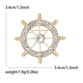 Minimalist ship wheel brooch with sparkling rhinestones in gold-tone metal finish - Gold
