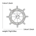Silver nautical helm brooch with sparkling white rhinestones and round center stone - Silver